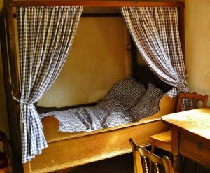 four poster bed in rustic room