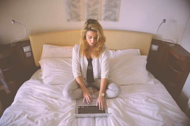 girl on laptop sat in bedroom