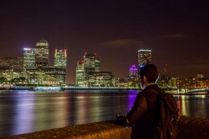 man looking at london at night